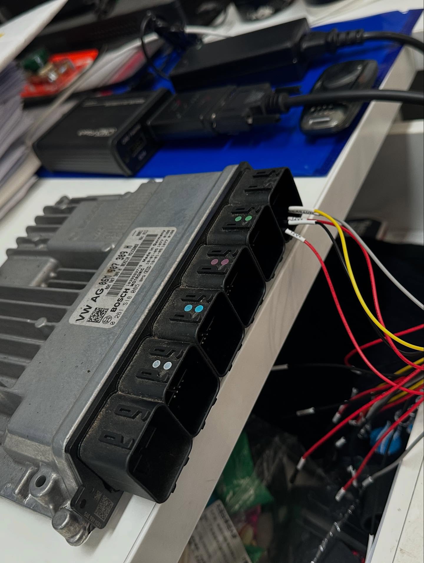 Engine control unit connected to wiring on a workshop bench