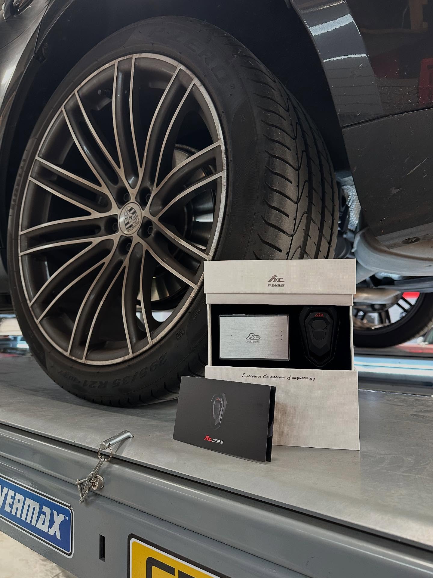 Large alloy wheel and tyre on a vehicle raised on a hoist
